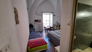 a bedroom with a bed and a room with a window at Malvasia rooms in Brindisi