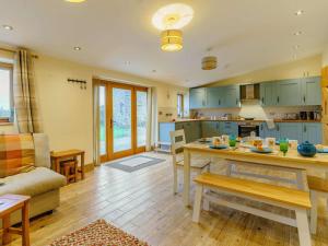 a kitchen and living room with a table and a couch at 3 Bed in Usk- oc-87286 in Llandenny