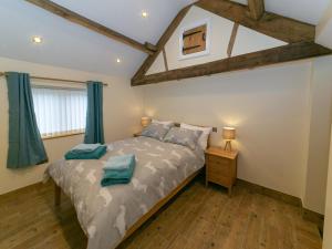 a bedroom with a bed and a wooden floor at 3 Bed in Usk- oc-87286 in Llandenny