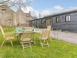a group of chairs sitting around a table in a yard at 3 Bed in Usk- oc-87286 in Llandenny