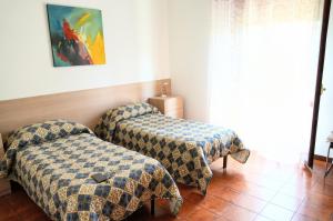 a room with two beds in a room at Cassiodoro Rooms Affittacamere in Catanzaro