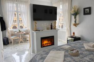 a living room with a fireplace with a tv on the wall at Barberini Dream in Rome