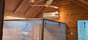 a room with a ceiling fan and a window at Sasvi Cabana in Trincomalee