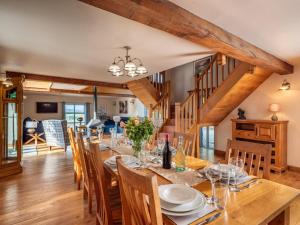 a dining room with a long wooden table and chairs at 5 Bed in Llangammarch Wells oc-bn162 in Garth