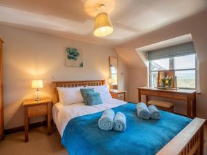 a bedroom with a large bed with blue sheets at 5 Bed in Llangammarch Wells oc-bn162 in Garth +21 photos