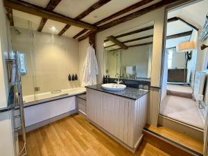 a bathroom with a sink and a bath tub at The Great House Lavenham Hotel & Restaurant in Lavenham +35 photos