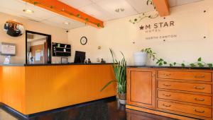 a salon with an orange counter in a room at M Star North Canton - Hall of Fame in North Canton