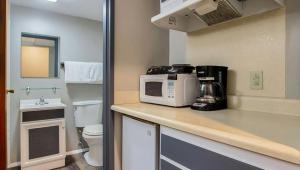 a small kitchen with a microwave on a counter at M Star North Canton - Hall of Fame in North Canton