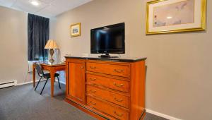 a room with a dresser with a television on top of it at M Star North Canton - Hall of Fame in North Canton