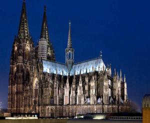 a large cathedral with turrets and spires at night at Cologne Apartment – City, Trade Fair, E-Werk in Cologne