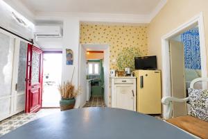 a kitchen with a table and a yellow refrigerator at Danielle 626 House Ano Syros in Ano Syros +57 photos