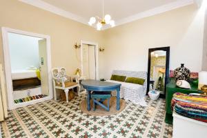 a living room with a table and a couch at Danielle 626 House Ano Syros in Ano Syros