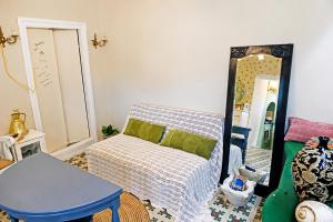 a living room with a couch and a mirror at Danielle 626 House Ano Syros in Ano Syros