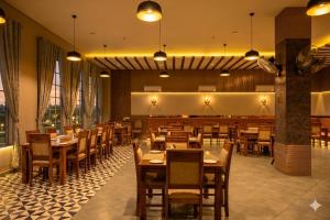 a dining room with wooden tables and chairs at Hotel ShyamLeela - Khatushyamji in Khātu