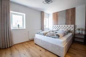 a large white bedroom with a large bed in it at Apartma na Grad in Ptuj