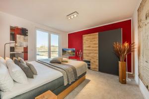 a bedroom with a large bed with red walls at Ein Traum am Haff in Zirchow