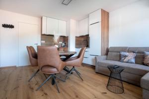 a living room with a table and chairs and a couch at Apartma na Grad in Ptuj +10 photos