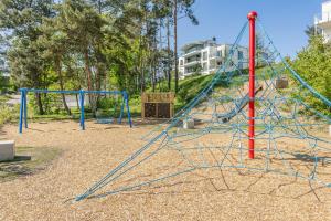 a playground with blue and red swings at Ein Traum am Haff in Zirchow