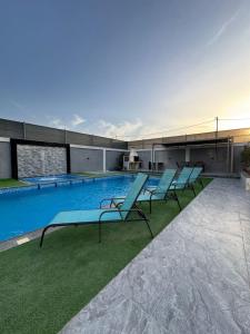a group of blue lounge chairs sitting on top of a building at aqua chalets شاليهات أكوا in Al Rama