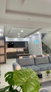 a living room with a couch and a table at aqua chalets شاليهات أكوا in Al Rama