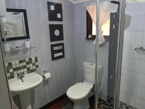a bathroom with a toilet and a sink at Log in At 118 Loghome in Meyerton