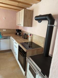 a small kitchen with a stove and a sink at Apostel Haus in Solnhofen