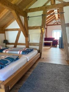 two beds in a room with wooden ceilings at Apostel Haus in Solnhofen