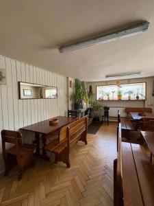 a dining room with wooden tables and benches at Dom Goscinny Jawor Czarnypotok in Krynica Zdrój