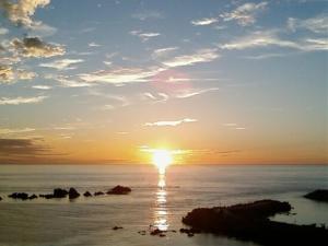 a sunset over the ocean with the sun setting at Pension Ora in Samcheok