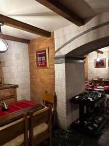 a kitchen with a stove top oven in a room at Oda Kuksit Hotel in Kukës