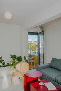 a living room with a couch and a table at áPero Suites in Trogir