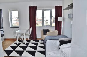 a living room with a black and white checkered floor at Apartments Lund in Lund