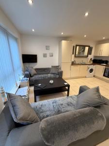 a living room with a couch and a table at Ballycastle, Beachside Apartment in Ballycastle