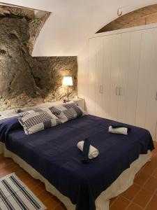 a bedroom with a large bed with towels on it at Loft con encanto in Cadaqués +8 photos