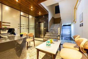 an office with a desk and chairs and a staircase at Hotel Silver Star in Greater Noida +15 photos