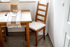 a wooden dining room table with a wooden chair at Bolter Mühle - DZ Hanfbuchte in Rechlin +24 photos