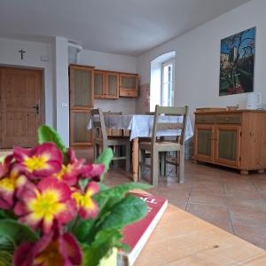 a kitchen with a table and a dining room at Maso Montel in Barco