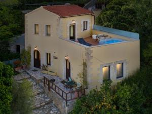 an aerial view of a house with a swimming pool at Villa Erontas -Private heated jacuzzi and mini pool in Makhairoí