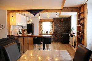 a kitchen with a table and some chairs at La Belle Tençoise in Tence