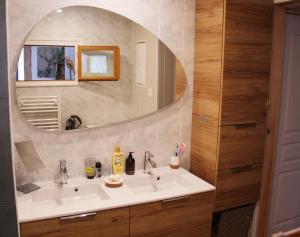 a bathroom with a sink and a mirror at La Belle Tençoise in Tence +13 photos