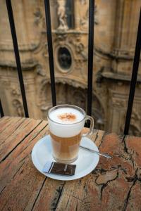 a cup of coffee on a plate on a table at Hotel Atari in San Sebastián +42 photos