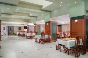 a dining room with tables and chairs in a building at Hotel Egreta in Tulcea