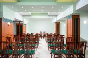 a row of chairs in a room with a large screen at Hotel Egreta in Tulcea