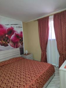 a bedroom with a bed with a red comforter at Villa la Perla in Lampedusa +89 photos