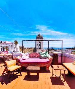 a couch sitting on top of a roof at El Beaterio Apartments in Tarifa