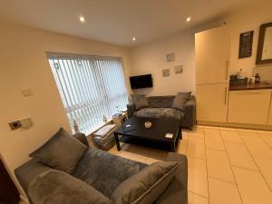 a living room with a couch and a table at Ballycastle, Beachside Apartment in Ballycastle