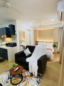 a living room with a bed and a couch at Neon AS Hotel in Pune