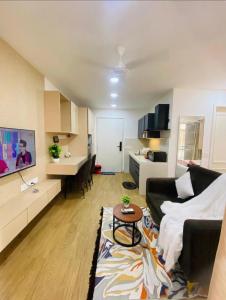 a living room with a couch and a table at Neon AS Hotel in Pune
