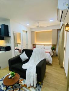 a hotel room with a bed and a couch at Neon AS Hotel in Pune