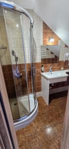 a bathroom with a shower and a sink at Pokoje Gościnne Leśna 33 in Sława +7 photos